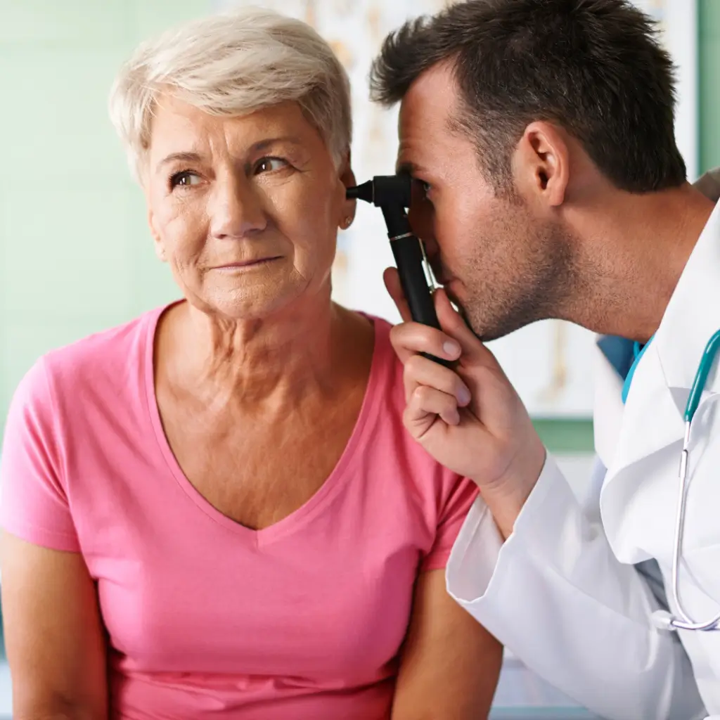 ENT doctor examining patient for pulsatile tinnitus and whooshing sound diagnosis